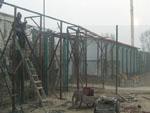 Workers repairing the enclosure in the presence of onlookers