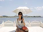 Sonya resting on a white stone chair
