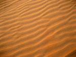 Patterns in the sand caused by wind erosion