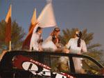 Teenagers sitting on car roof