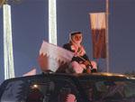 Man Sitting on car roof with Qatar flag